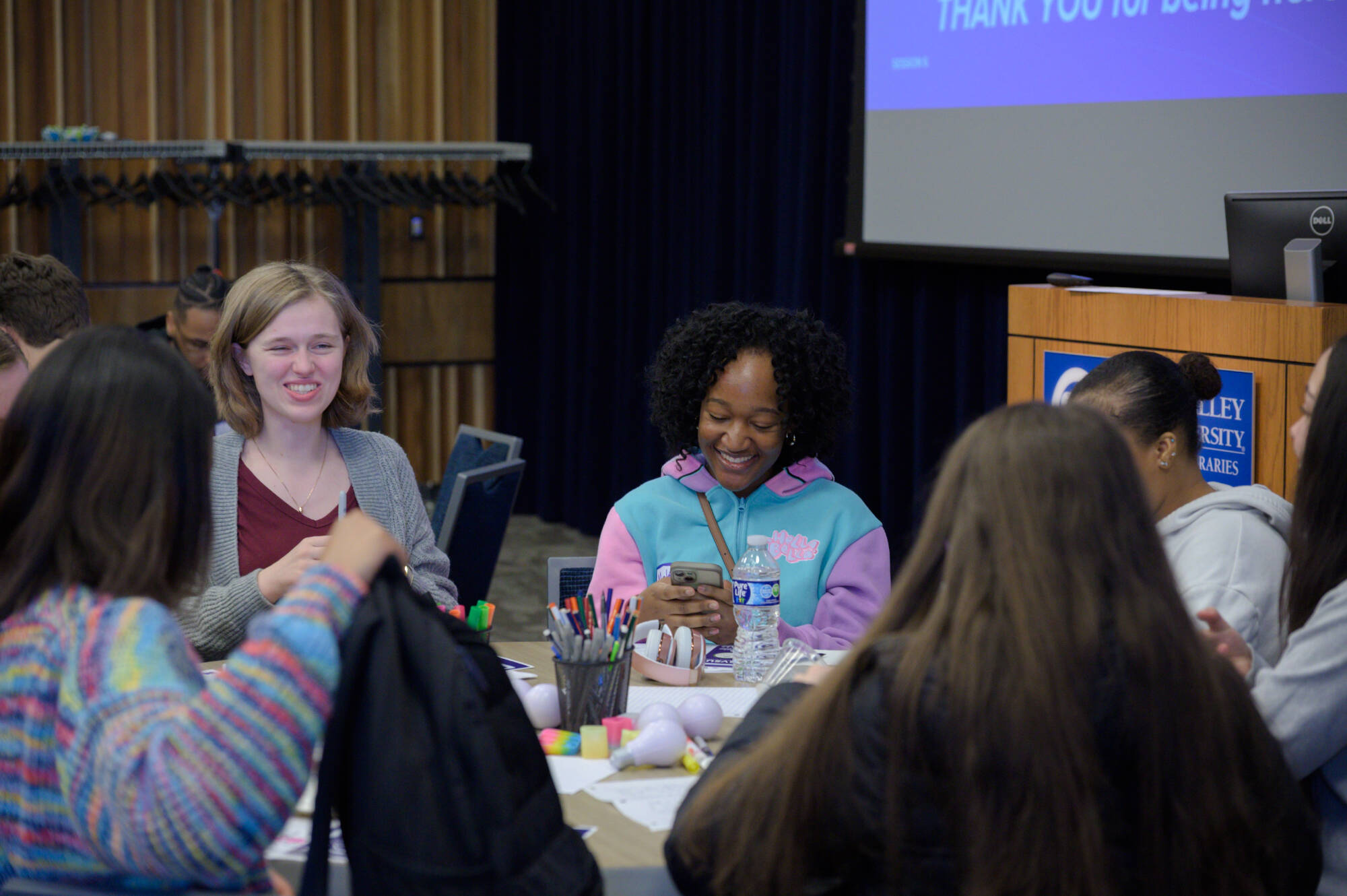 A photo of students sitting on a  round table during Thompson & Charter Leadership Series